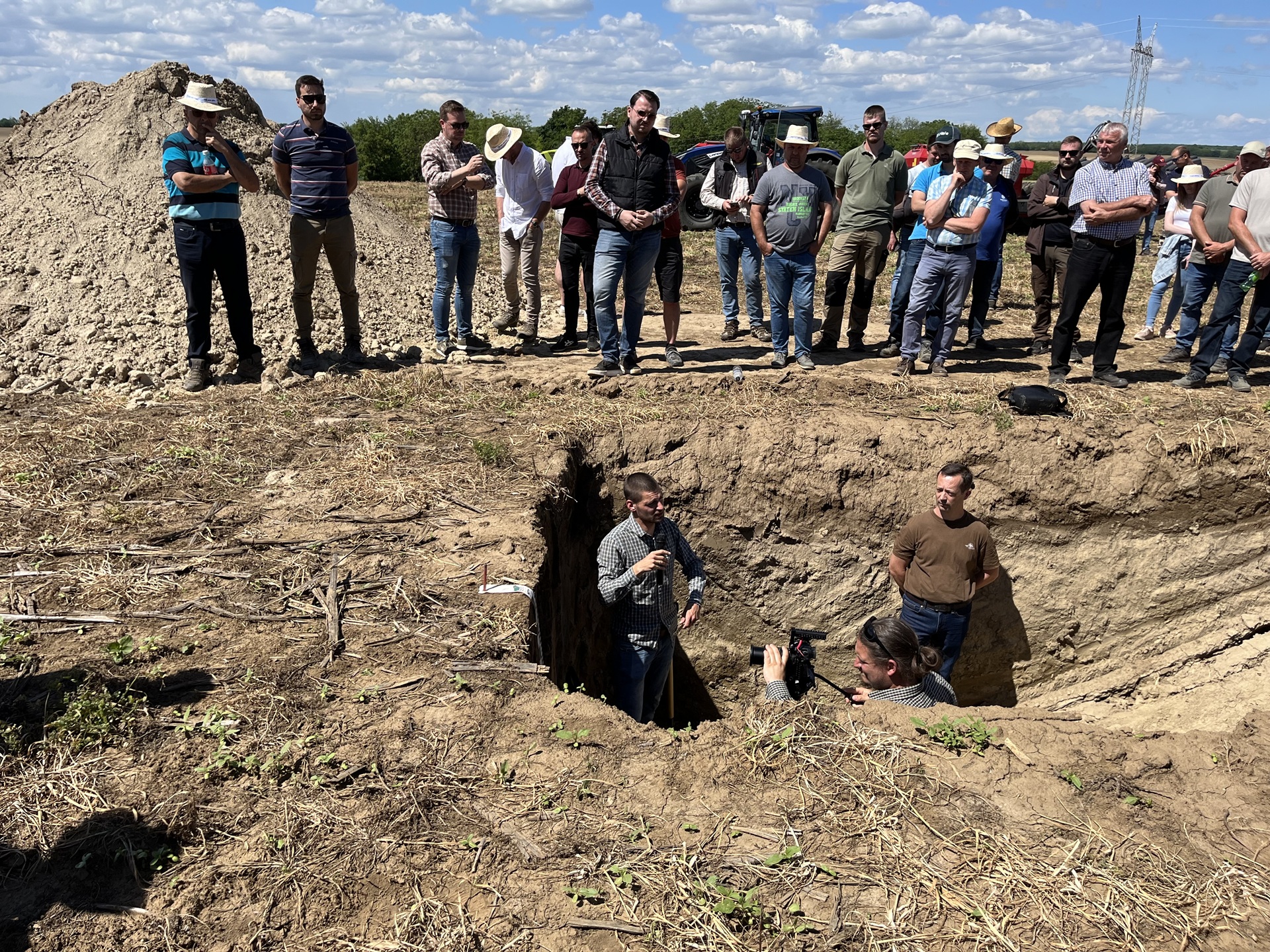 Team inspecting a soil pit in a field